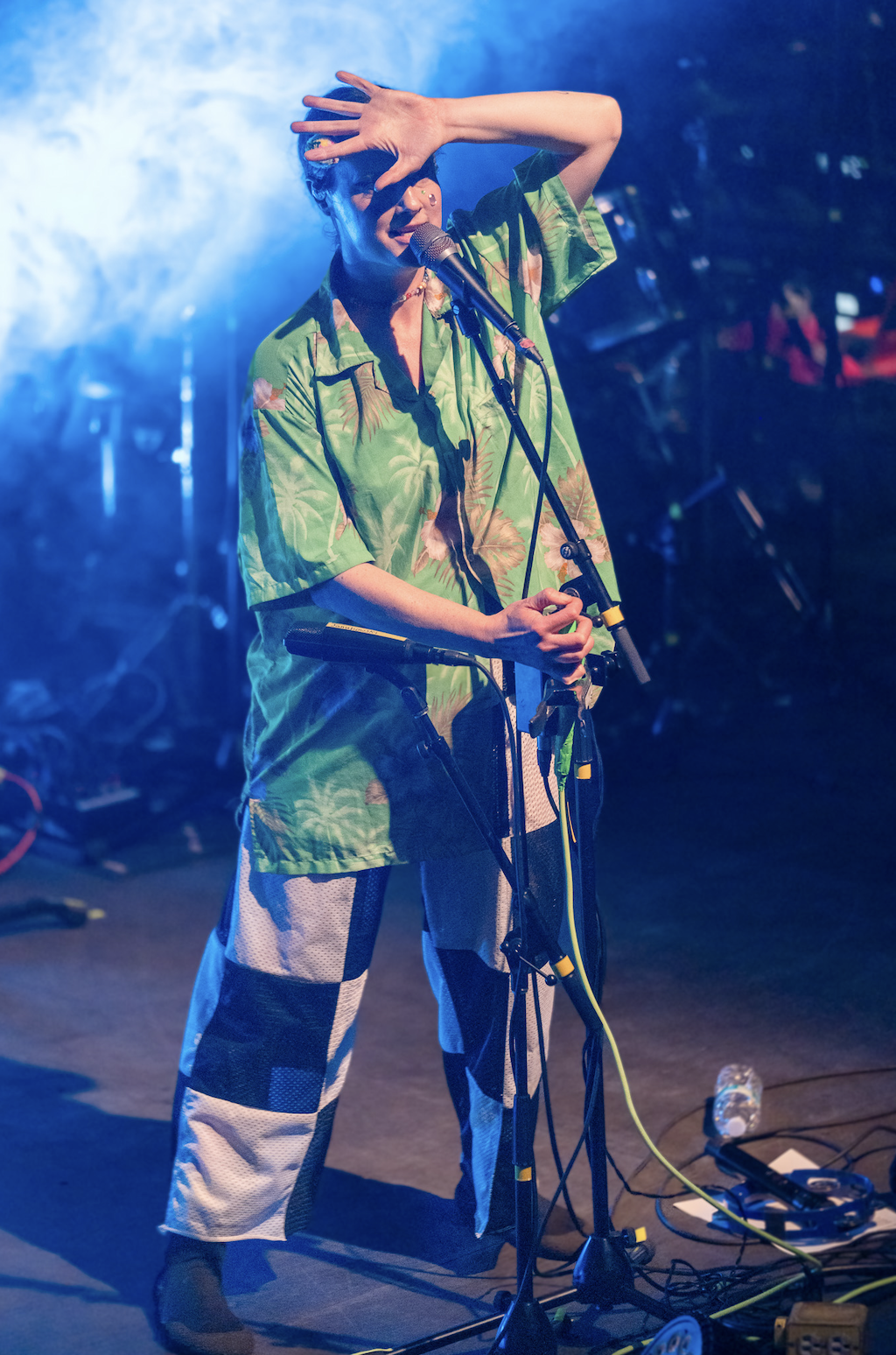 Performer on stage under blue lights