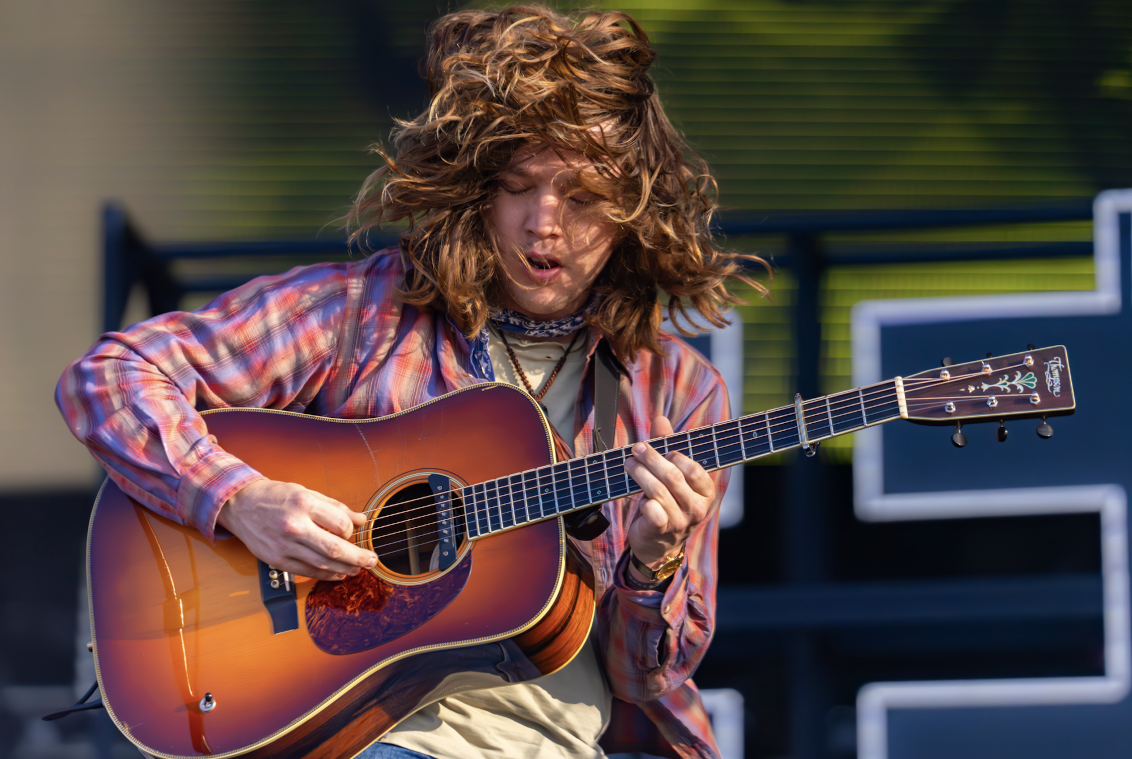 Guitarist playing acoustic guitar on stage